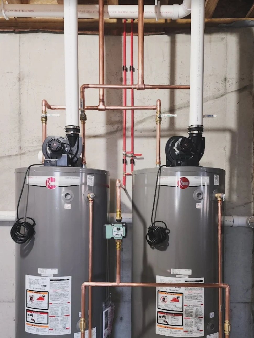 Twin Rheem power-vent water heaters with copper piping